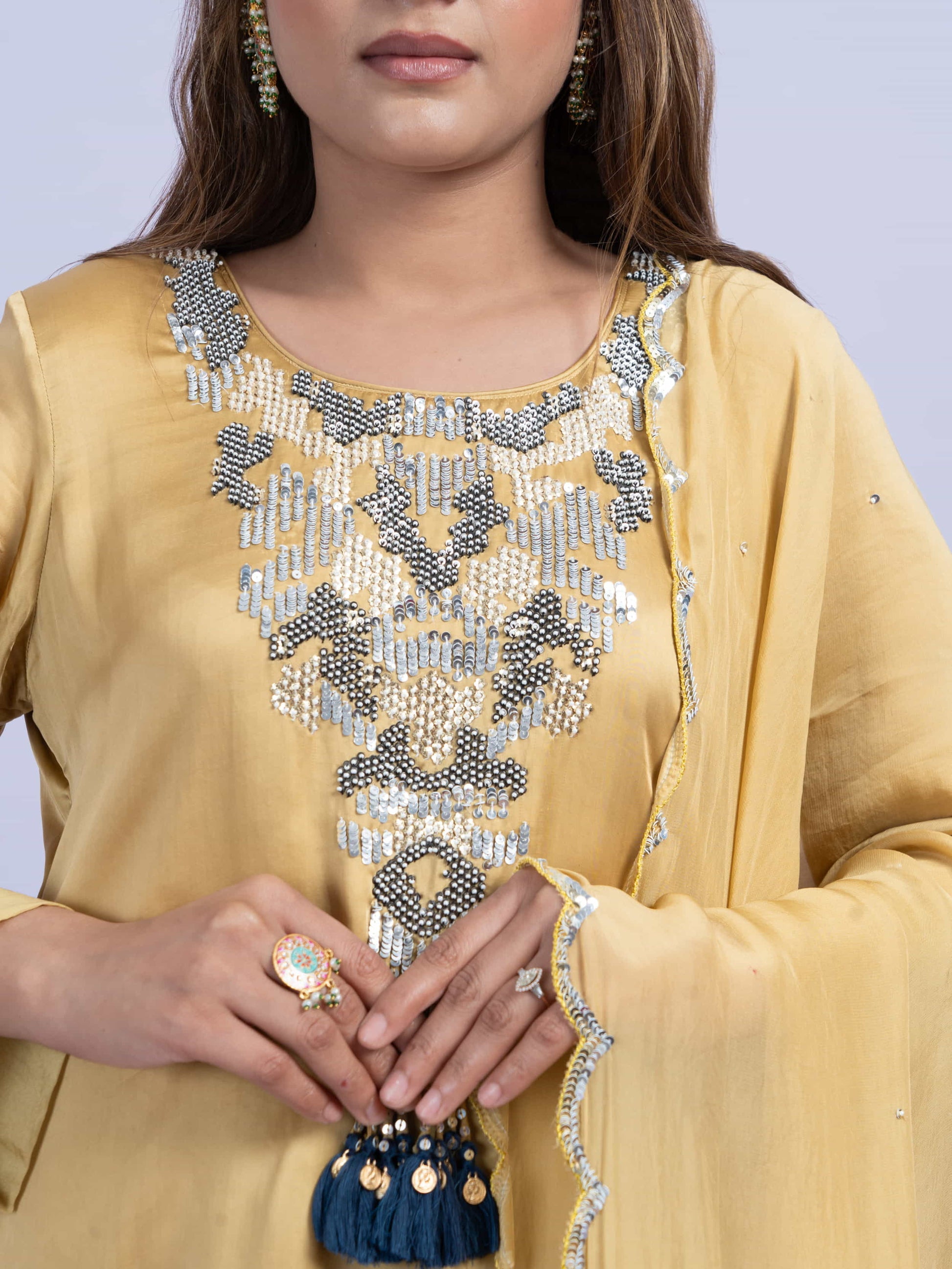 Mustard kurta set with embroidery on neck paired with dhoti pants and dupatta