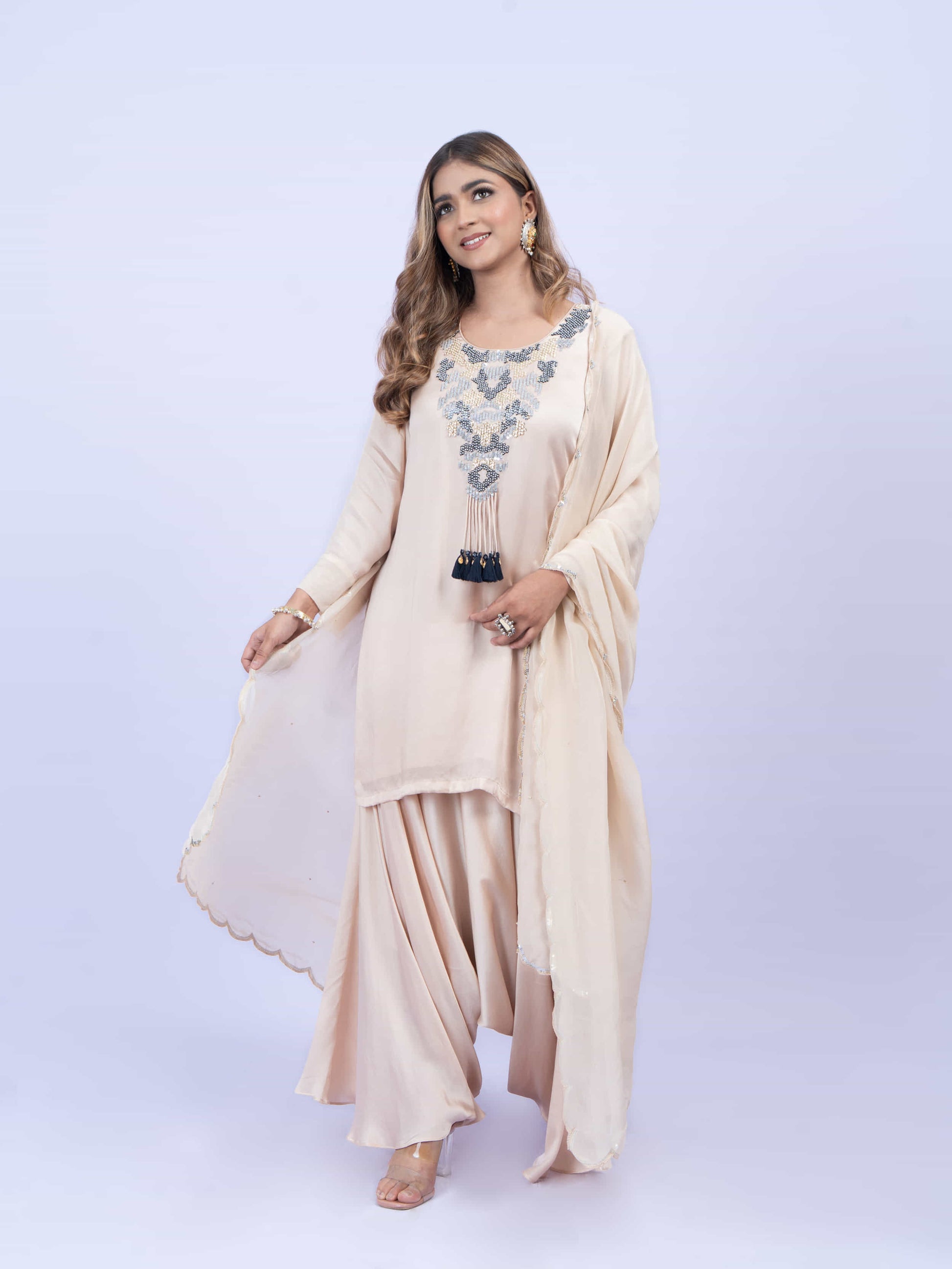 Ivory kurta set with embroidery on neck paired with dhoti pants and dupatta