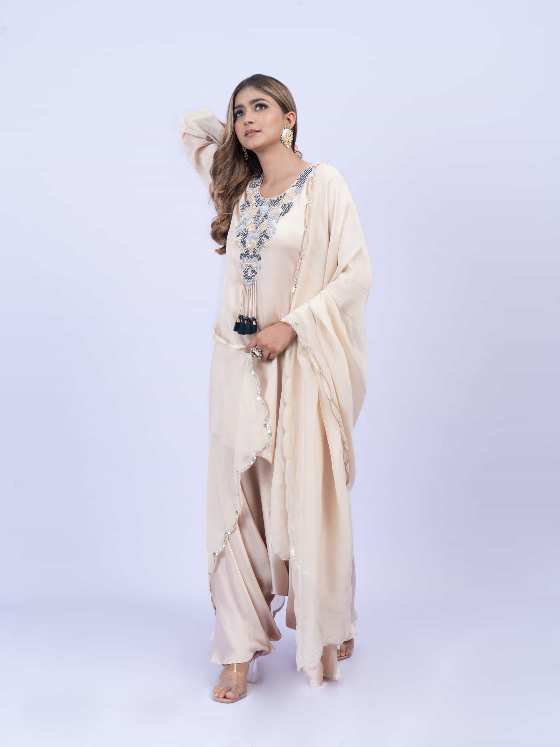 Ivory kurta set with embroidery on neck paired with dhoti pants and dupatta
