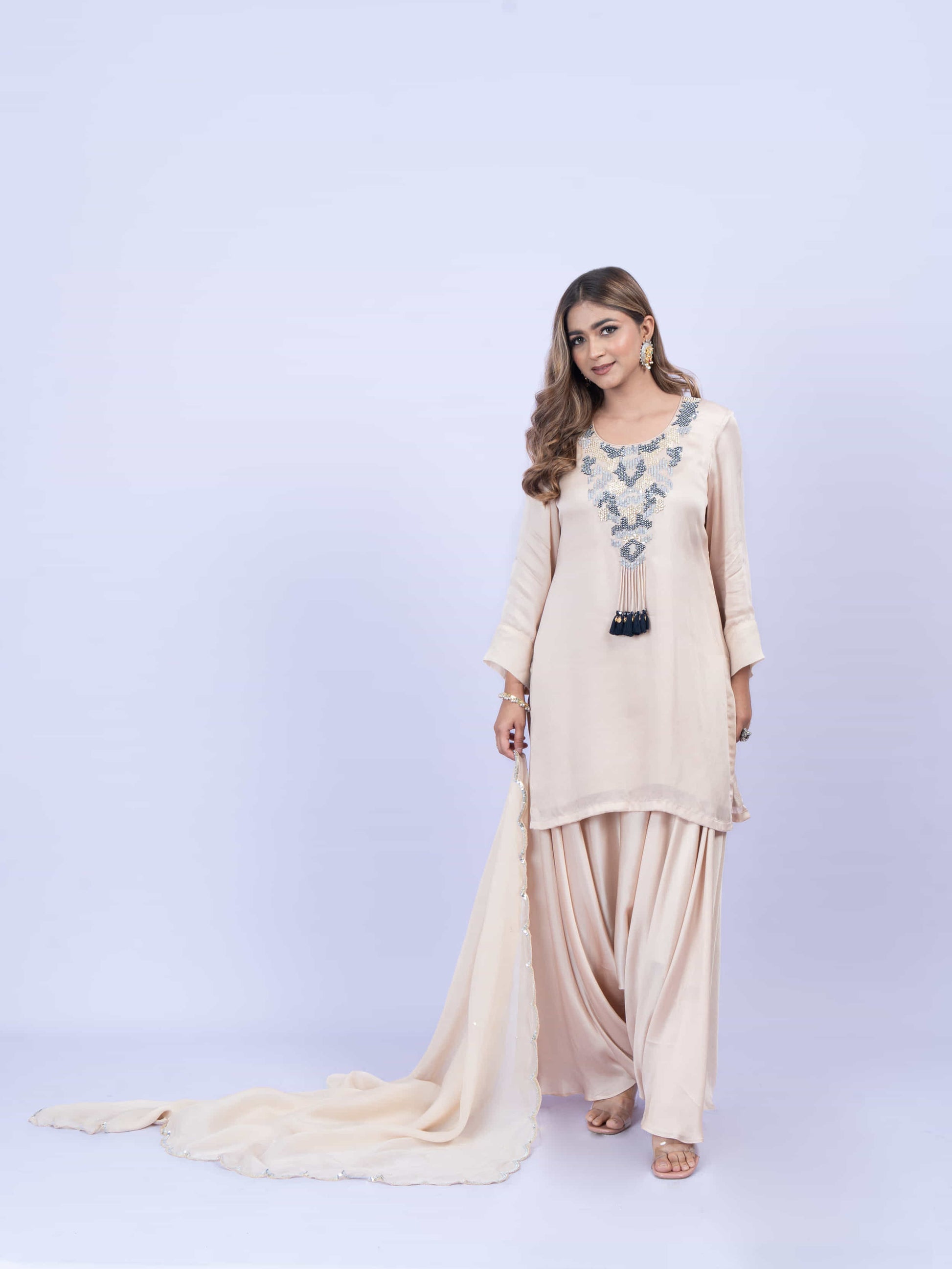Ivory kurta set with embroidery on neck paired with dhoti pants and dupatta