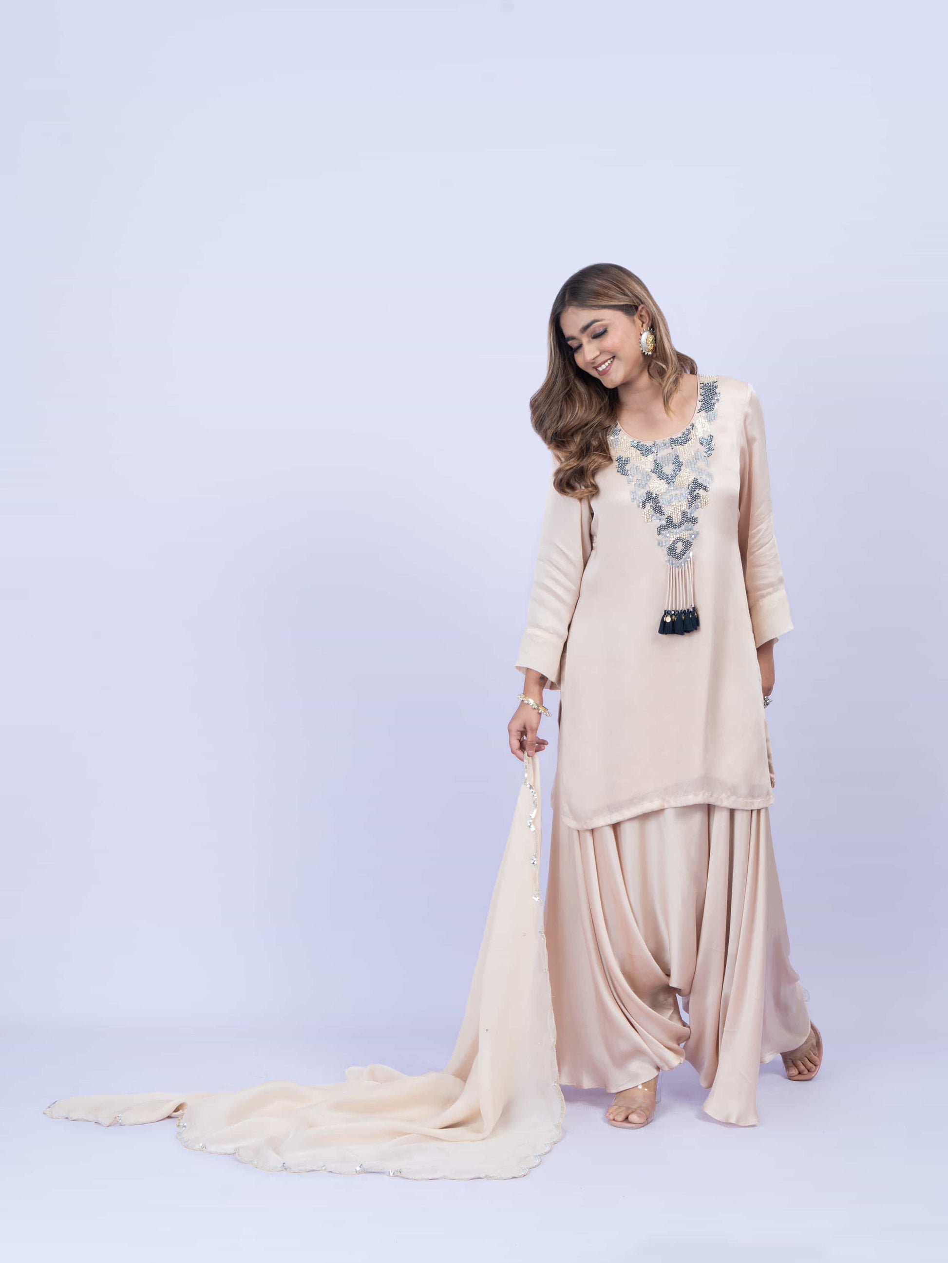 Ivory kurta set with embroidery on neck paired with dhoti pants and dupatta