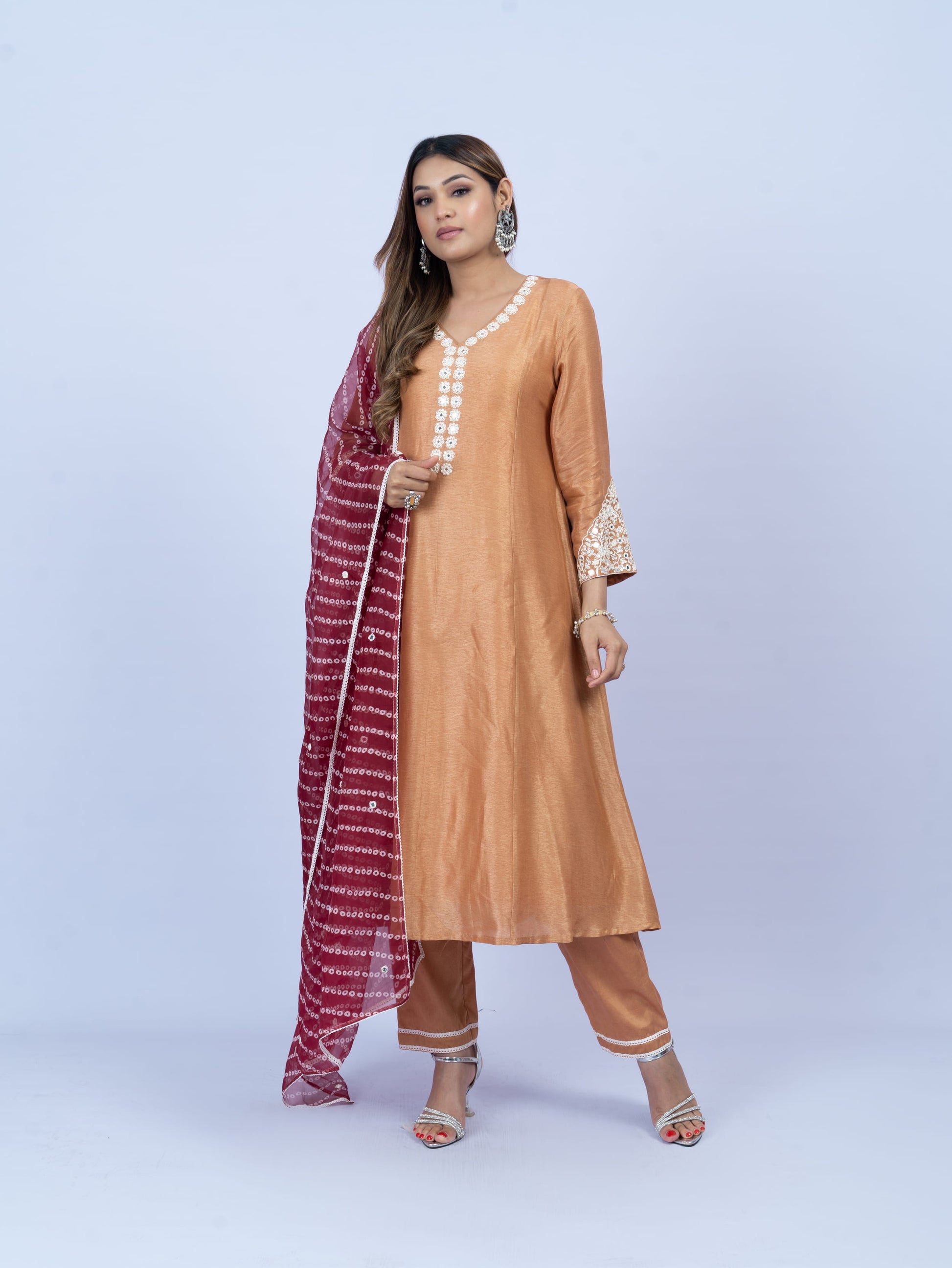 solid kurta set with hand embroidery on neck and sleeves paired with bandhni dupatta