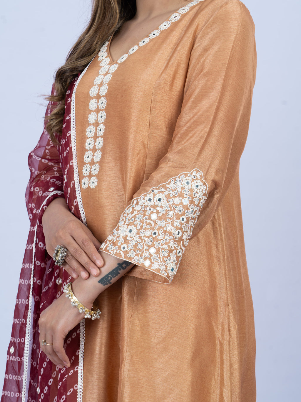solid kurta set with hand embroidery on neck and sleeves paired with bandhni dupatta